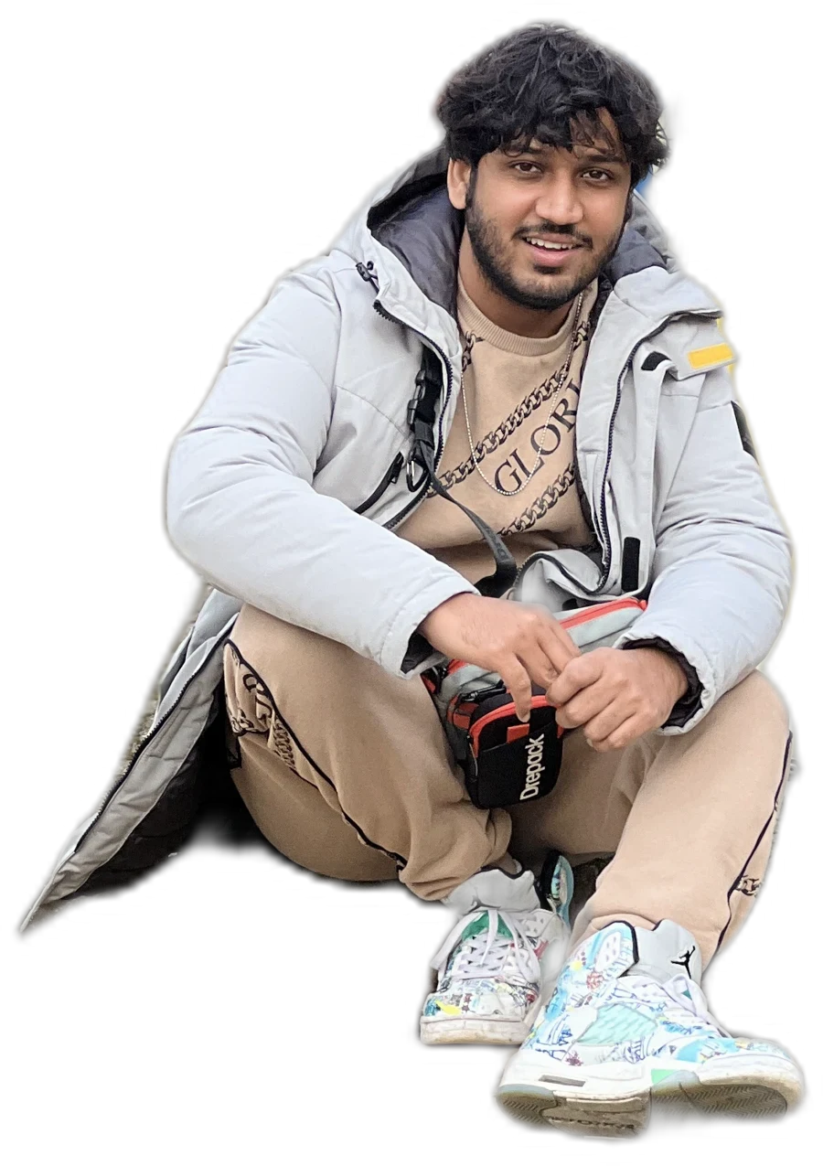 Akshit sitting cross-legged, smiling